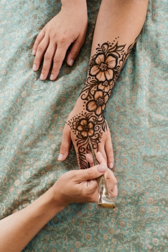henna-tattoo-on-woman-hands-artist-drawing-arabic-2021-12-30-19-36-15-utc